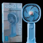 : Light blue portable handheld fan with cute bunny emblem standing next to its box packaging.